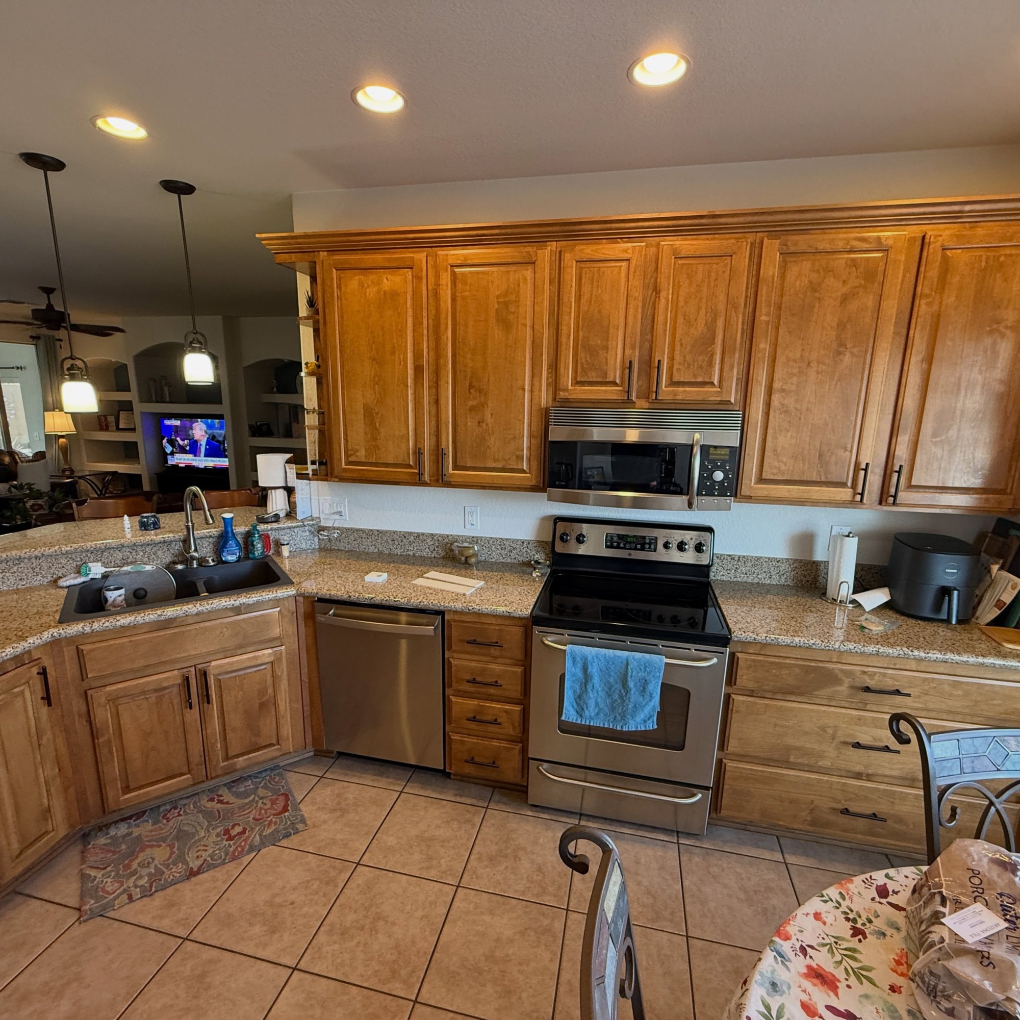 Before: original oak cabinetry and tile backsplash.
