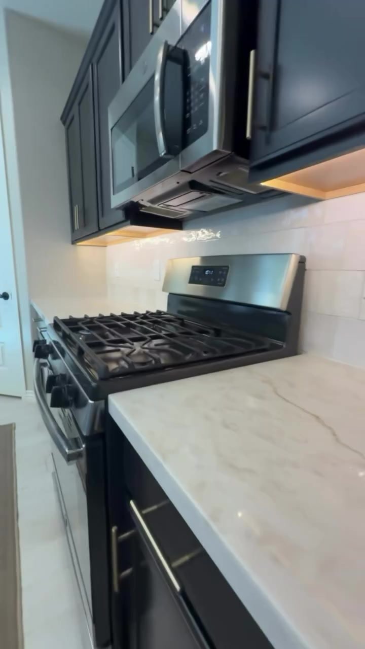 Countertop and backsplash finished around the gas range.