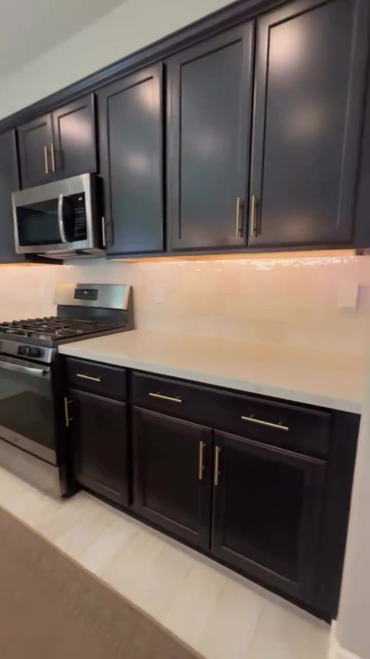 New tile backsplash between the counters and the espresso upper cabinets.